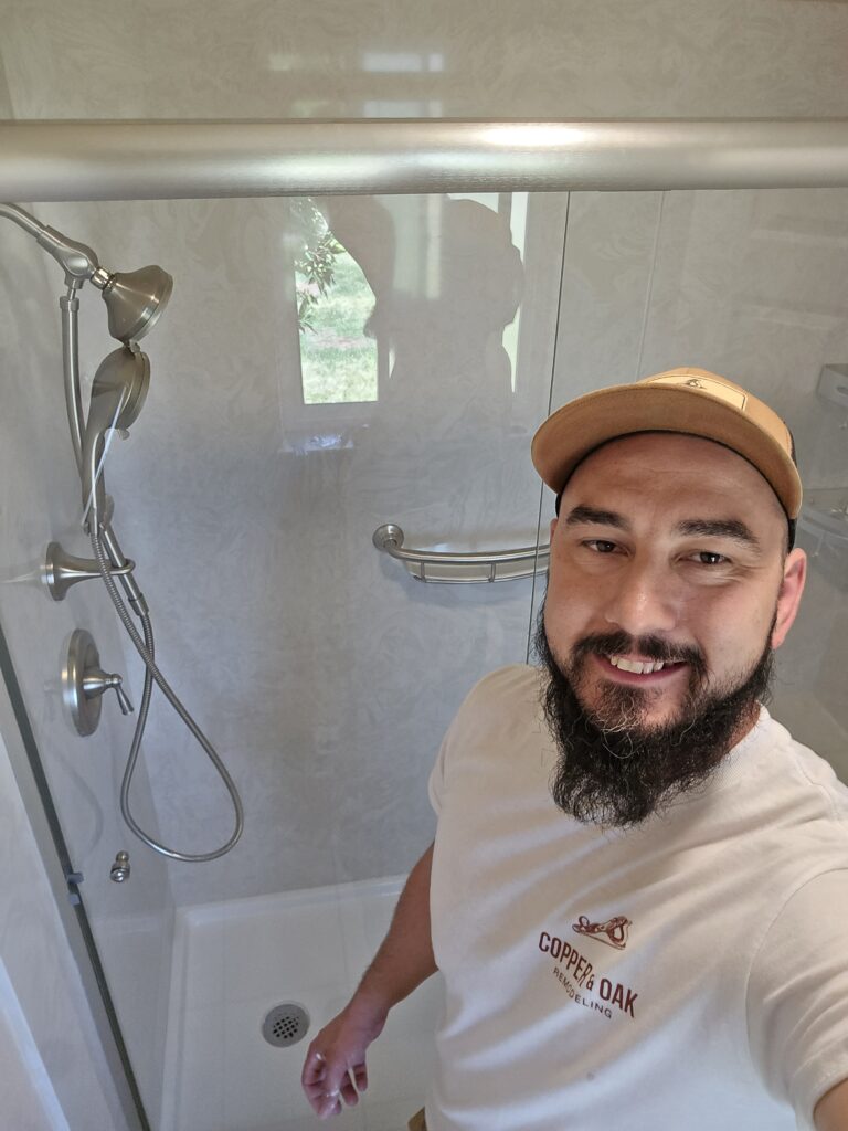 Cody Seibel in front of newly remodeled quartz shower.