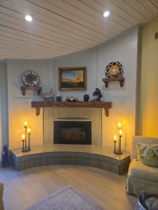 Remodeled corner fireplace with red oak shelves and sage tile hearth